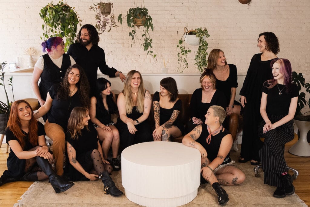 The team at Twig Hair Salon Boulder, Colorado poses for a photo in a studio atmosphere